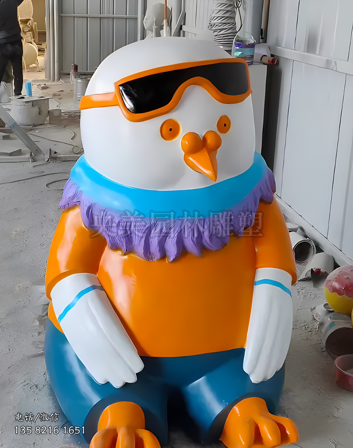 戴墨鏡坐地上的卡通雞雕塑